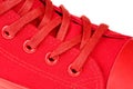 Extreme close up of red womens high top lace up sneaker isolated on white background