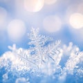 Extreme close-up of a single, intricate snowflake with hexagonal symmetry on a soft blue background Royalty Free Stock Photo