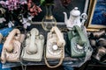 Antique or rare wired telephones, ceramic teapot, vase, coppers and other retro objects on the desk outdoor. day lighted, extreme