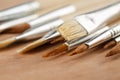 Extreme close up of a set of art paint brushes on a wooden palette. Shallow depth of field Royalty Free Stock Photo