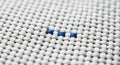 Extreme Close-up of White Woven Fabric with Three Blue Stitches textile weave Royalty Free Stock Photo