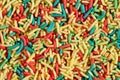 Extreme close up, top down view of colorful sugar sprinkles. Macro food texture background