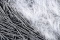 Extreme close up, top down view of polypropylene filament micro fibers and steel, end hooked fibers for concrete structural