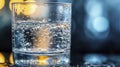 An extreme close-up of a transparent glass filled with drinking water, illuminated by a bright light source Royalty Free Stock Photo