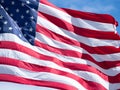 Extreme Close Up of an American Flag with Blue Sky and Thin Clouds in Background Royalty Free Stock Photo