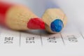 Red and blue color pencil tips on balance sheet Royalty Free Stock Photo