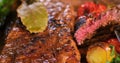 Extreme close up view of a sirloin steak with asparagus, potatoes and roasted tomatoes