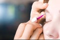 Extreme close-up of a young woman plucking eyebrow hair with tweezers in a beauty salon Royalty Free Stock Photo