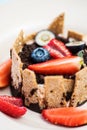 Extreme closeup of dessert with tonka cream, chocolate and berries