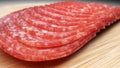 extreme closeup, detailed. salami sausage cut into thin pieces on a wooden board Royalty Free Stock Photo