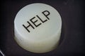 Extreme closeup of a help button on a remote Royalty Free Stock Photo