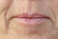 Extreme Closeup on the mouth of a middle-aged woman