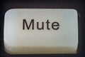Extreme closeup of a mute button on a TV remote Royalty Free Stock Photo