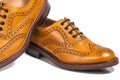 Extreme Closeup of A Pair of Full Broggued Tan Leather Oxfords Shoes. Royalty Free Stock Photo