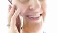 Extreme closeup photo of young smiling woman talking by mobile phone Royalty Free Stock Photo