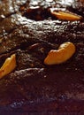 Extreme closeup with shallow depth of field of freshly baked rich, moist chocolate plum cake