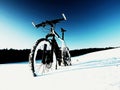 Extreme contrast. Mountain bike stay in powder snow. Lost path in deep snowdrift.