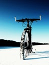 Extreme contrast. Mountain bike stay in powder snow. Lost path in deep snowdrift.