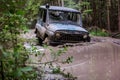 Extreme driving, challenge and 4x4 vehicles concept. Offroad race in forest. SUV or offroad car rides in a deep puddle Royalty Free Stock Photo