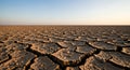Extreme drought cracked earth under a sunset sky Royalty Free Stock Photo