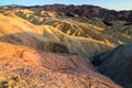 Colorful Eroded Ridges of Zabriskie Point, dry mudstone mountains, volcanic shaped, lifeless landscape during setting sun light Royalty Free Stock Photo