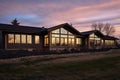 extreme long shot of a single-story house, ribbon windows show prairie