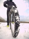 Extreme low angle close view to mountain bicycle blocked in snowy icy trail. Extreme wide view Royalty Free Stock Photo