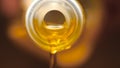 Extreme macro of olive oil poured from an original bottle. Stock footage. Close-up of oil pouring out of the bottle Royalty Free Stock Photo