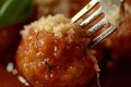 Extreme macro shot of a fork holding a crispy fried cheese ball Royalty Free Stock Photo