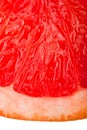 Extreme macro shot of a red grapefruit isolated on Royalty Free Stock Photo