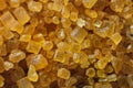 Extreme macro. Sugar crystals. Close-up of brown cane sugar on a plane. Texture or background of wholesome brown sugar