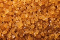 Extreme macro. Sugar crystals. Close-up of brown cane sugar on a plane. Texture or background of wholesome brown sugar