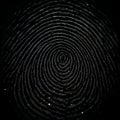 Extreme close up macro view of a dark fingerprint with intricate swirling ridges and subtle light reflections Royalty Free Stock Photo