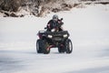 extreme Moto rider in gear on the ATV in the winter in the snow Royalty Free Stock Photo
