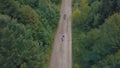 Extreme motorcyclists rides on road in the forest. Motocross. Motosport.