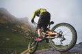 Extreme mountain bike sports athlete man in helmet riding outdoors against a background of rocks. Lifestyle. Trial Royalty Free Stock Photo