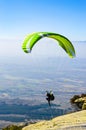 Extreme paragliding, man running and jumping to take off the cliff
