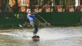 Extreme Park, Kiev, Ukraine, 07 may 2017 - a young girl, accustomed to ride Wakeboarding. Photo of grain processing