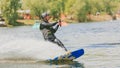 Extreme Park, Kiev, Ukraine - may, 07, 2017 - a young man practiced jumping at Wakeboarding. Photo processing grain.