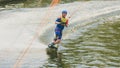 Extreme Park, Kiev, Ukraine - may, 07, 2017 - a young man practiced jumping at Wakeboarding. Photo processing grain.
