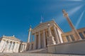 Extreme perspective of the national academy of Athens neo classical building facade under blue sky with sun rays, Greece Royalty Free Stock Photo