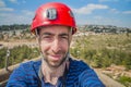 Extreme professional climber taking selfie photo on the top of c