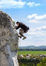 Extreme rock climbing, man on natural wall with blue sky. Royalty Free Stock Photo