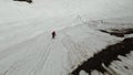 Extreme ski rider jumping from ledge drop and shifty in flight aerial view FPV sports drone shot