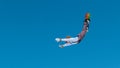 Extreme snowboarder catches big air and does a backflip with outstretched arms. Royalty Free Stock Photo