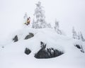 Extreme Snowboarder Jumping Off Powder Cliff Holding Grab in Backcountry Royalty Free Stock Photo