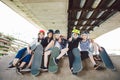 Extreme sport in city. Skateboarding Club for children. Group friends posing on ramp at skatepark. Early adolescence in skate