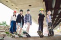 Extreme sport in city. Skateboarding Club for children. Group friends posing on ramp at skatepark. Early adolescence in skate