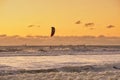 Extreme Sport Kitesurfing, cargo ships on the horizon. Surfer in the sea at Scheveningen at sunset