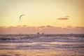 Extreme Sport Kitesurfing, cargo ships on the horizon. Surfer in the sea at Scheveningen at sunset